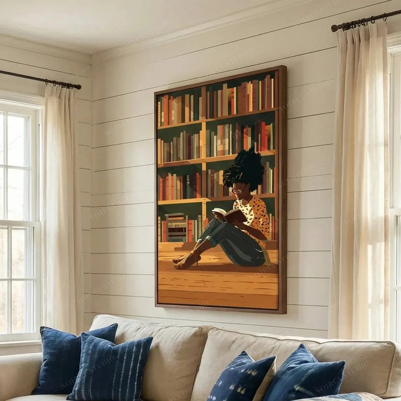 Black art for living room, girl reading canvas above a cream sofa with indigo pillows on a shiplap wall
