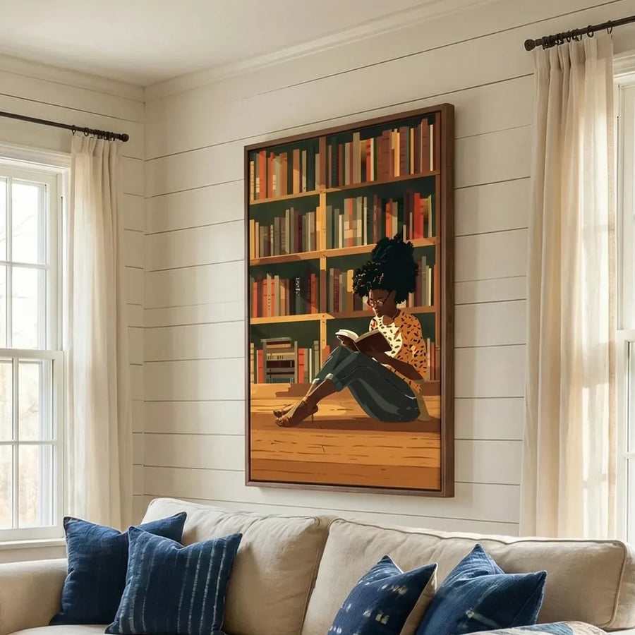 Black art for living room, girl reading canvas above a cream sofa with indigo pillows on a shiplap wall