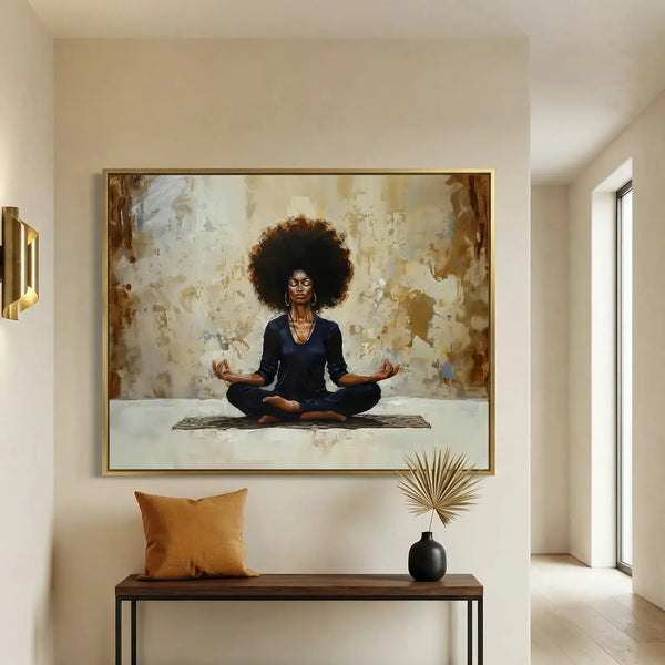 Afrohemian wall art of a Black woman meditating, gold frame above an entryway console with an ochre pillow