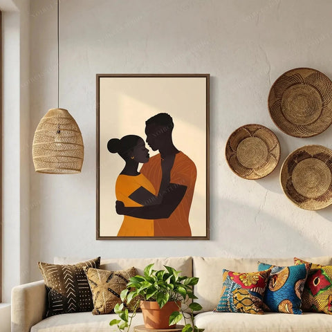 Black love art in a walnut frame above a cream sofa with mudcloth pillows and woven baskets, couple embracing