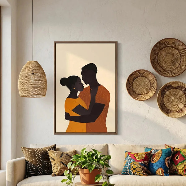 Black love art in a walnut frame above a cream sofa with mudcloth pillows and woven baskets, couple embracing