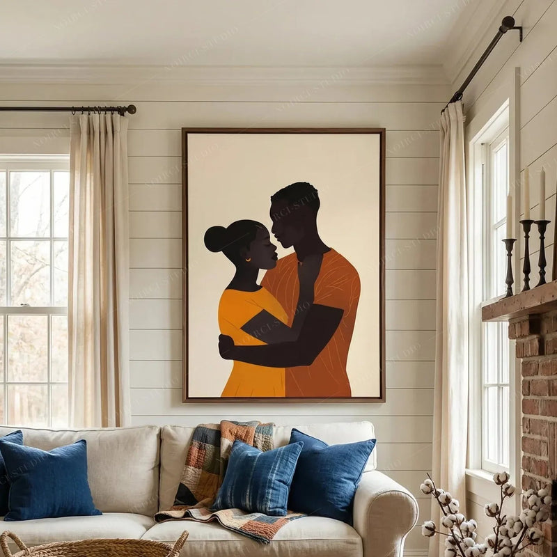 Black art for living room, couple embrace canvas in a walnut frame above a sofa with indigo pillows on shiplap