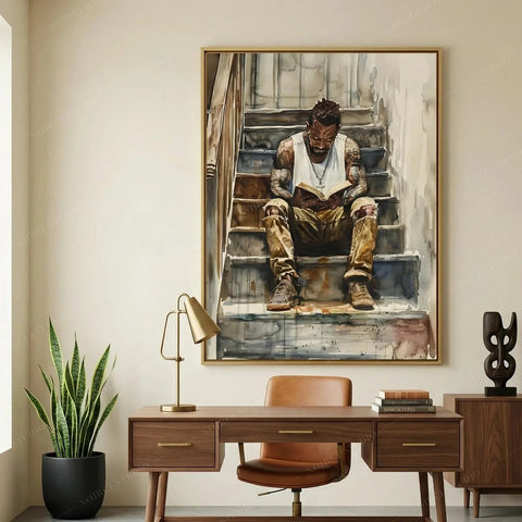 Harlem Renaissance art above a walnut desk and snake plant in a home office, watercolor of a Black man reading on stairs