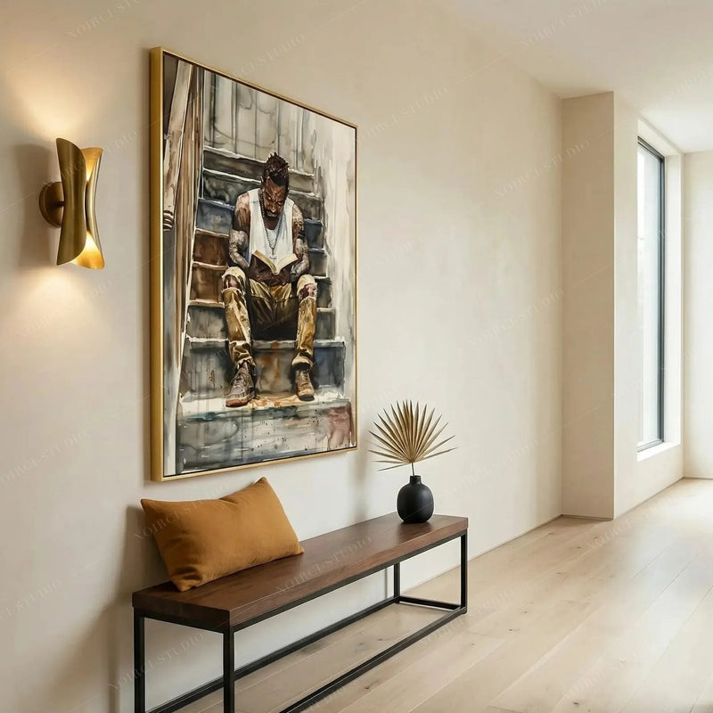 Modern Black art for apartment in a hallway with gold sconce, walnut bench and dried palm, man reading watercolor