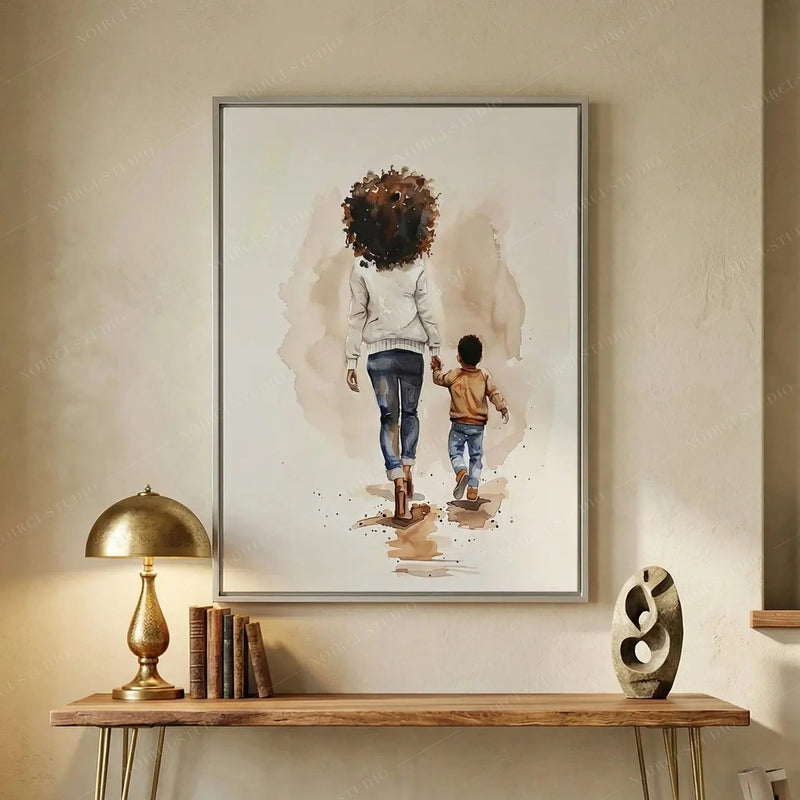 African American hallway art above a wood console with brass lamp and books, mother and son walking watercolor