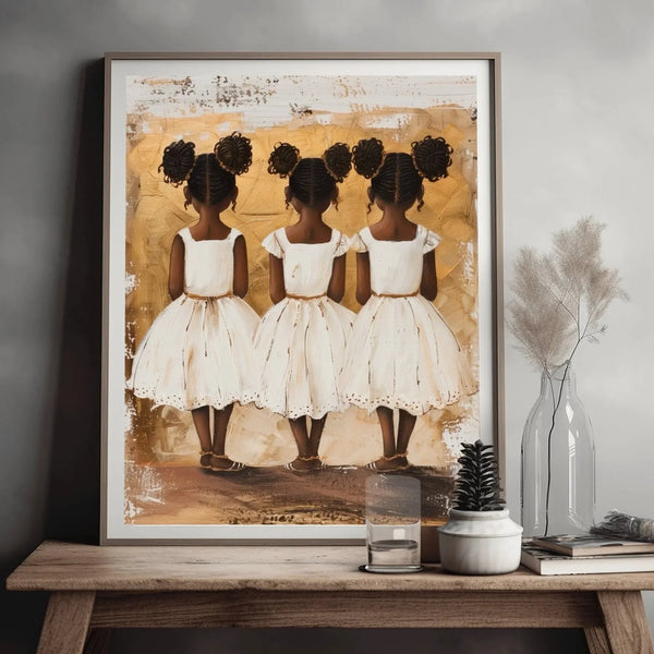 Black family art of three little sisters in white dresses, gold-toned painting styled on a wood bench with dried stems
