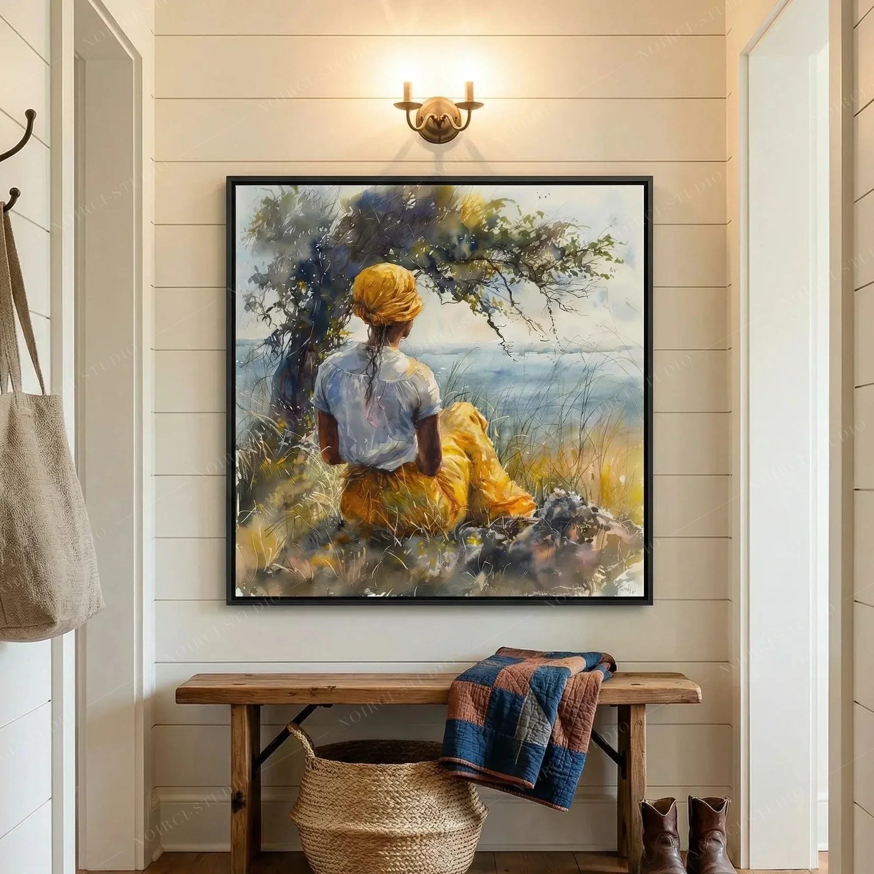 Lowcountry art in a shiplap mudroom, framed watercolor above a wood bench with a quilt and woven basket