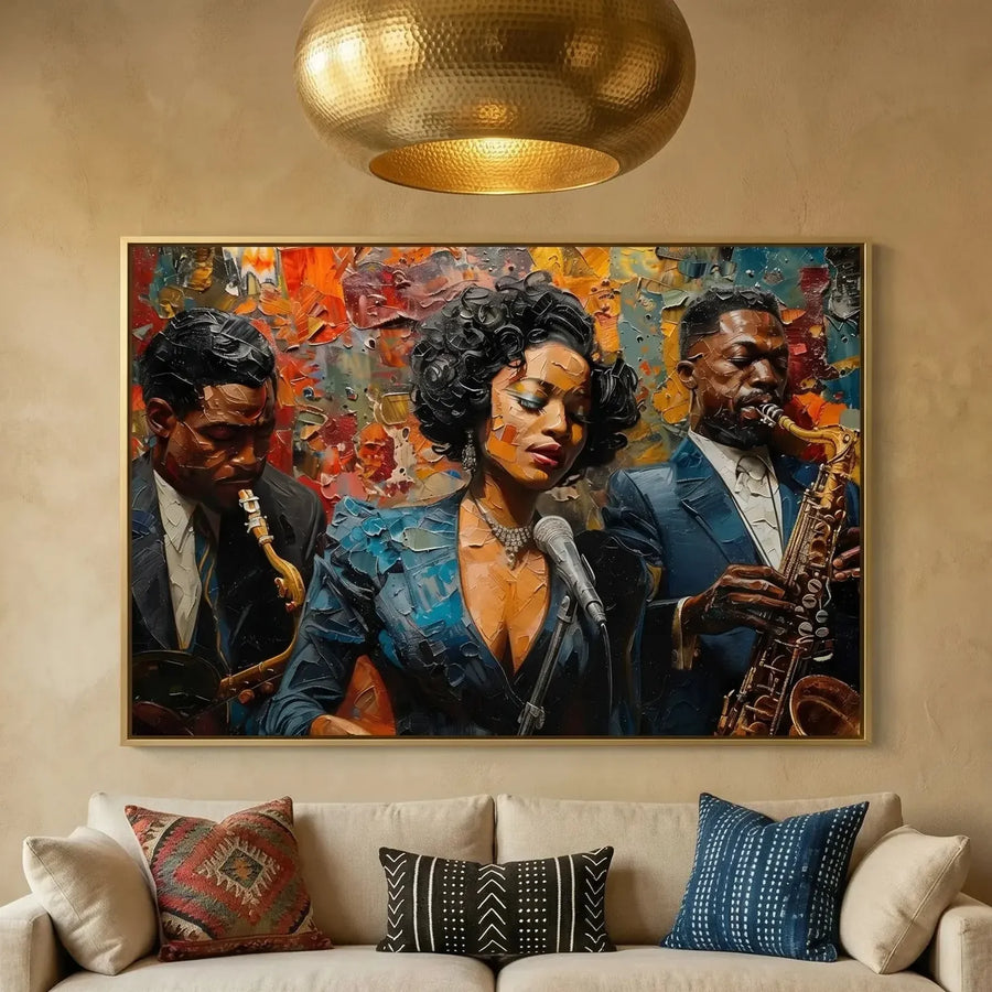 Black art for living room decor, jazz trio painting on a plaster wall above a cream sofa with kilim pillows