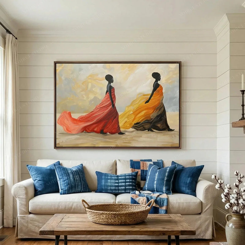 African art for living room walls, women in flowing gowns above a white sofa with indigo pillows and shiplap
