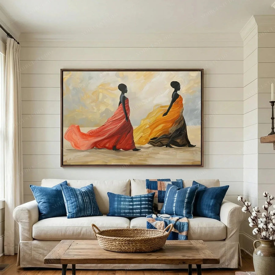 African art for living room walls, women in flowing gowns above a white sofa with indigo pillows and shiplap