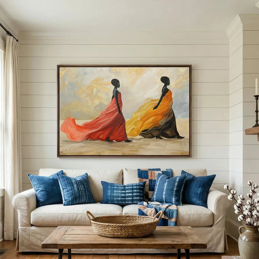 African art for living room walls, women in flowing gowns above a white sofa with indigo pillows and shiplap