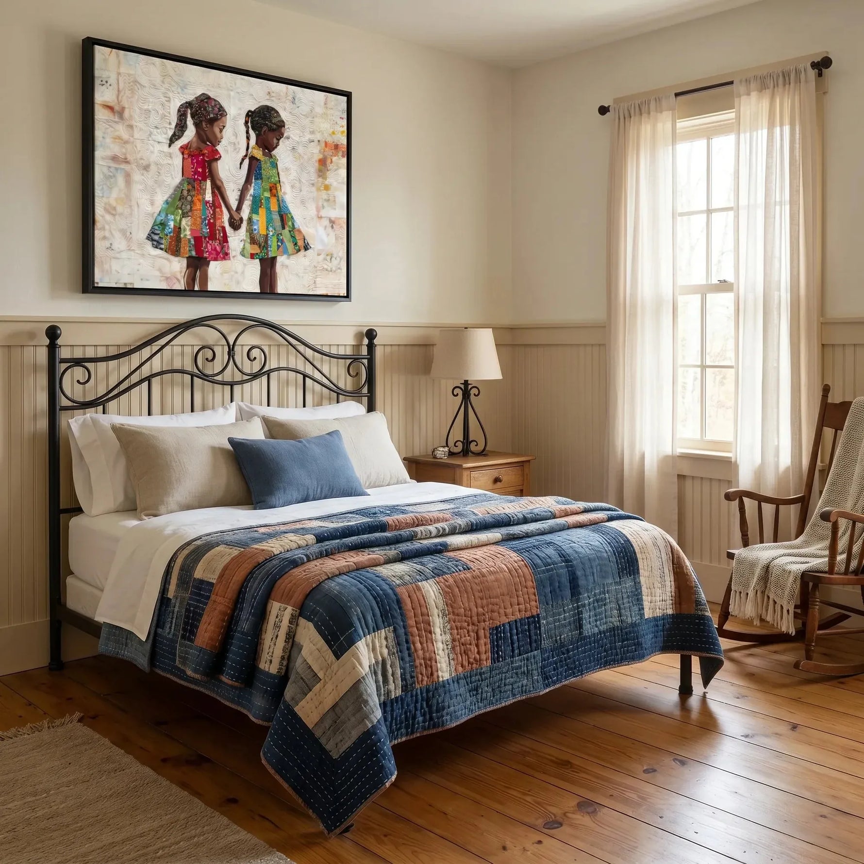 Two sisters quilt art above a black iron bed dressed in a patchwork quilt in a vintage farmhouse bedroom