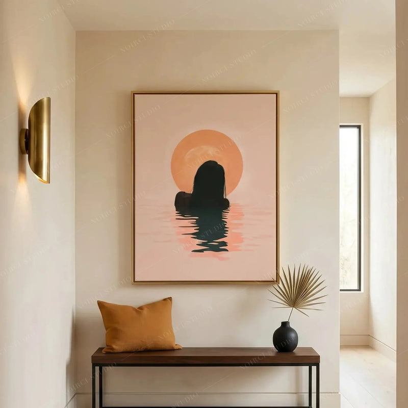 African American art for an entryway, gold-framed sunrise silhouette above a wood bench with a mustard cushion