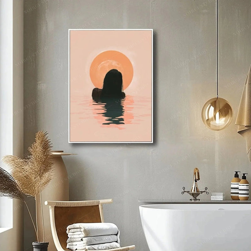 Black bathroom wall art, sunrise swim canvas in a white frame beside a freestanding tub and dried pampas stems