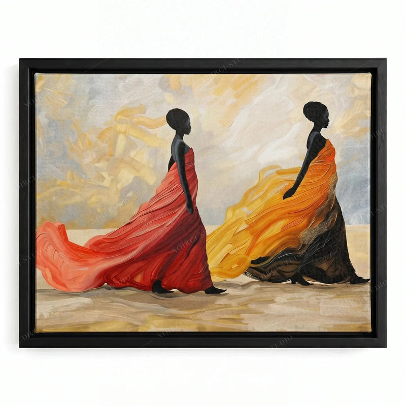 African canvas art in a black floating frame, two Black women in swirling coral and orange dresses crossing warm sand