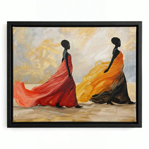 African canvas art in a black floating frame, two Black women in swirling coral and orange dresses crossing warm sand