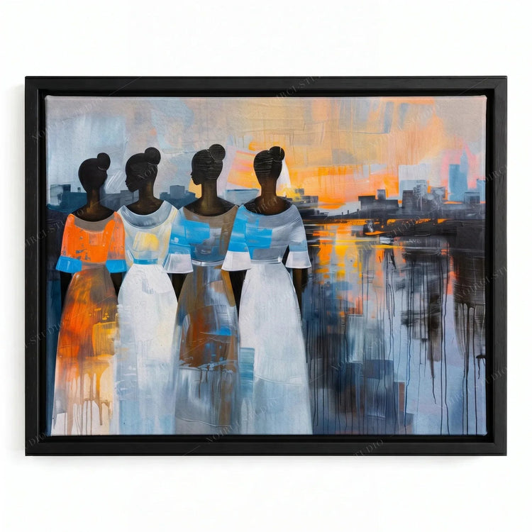 Modern African tribal art in a black floating frame, four women in white and blue dresses facing a waterfront sunset