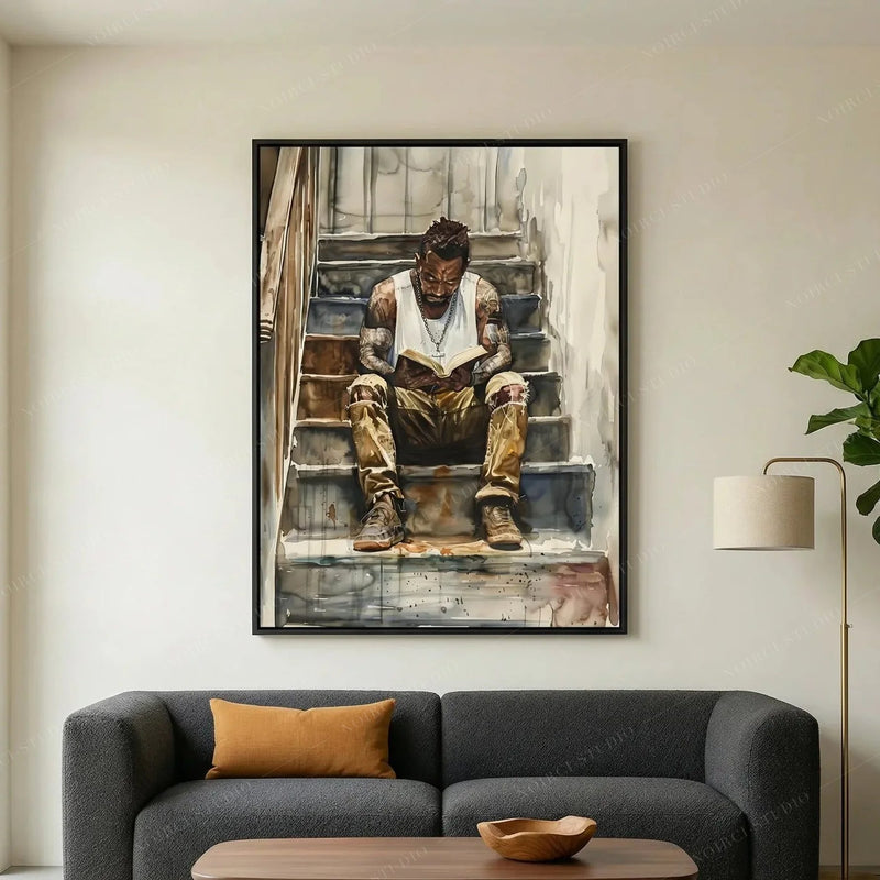 Black art for living room above a charcoal sofa with mustard pillow and fiddle leaf fig, man reading on stairs watercolor