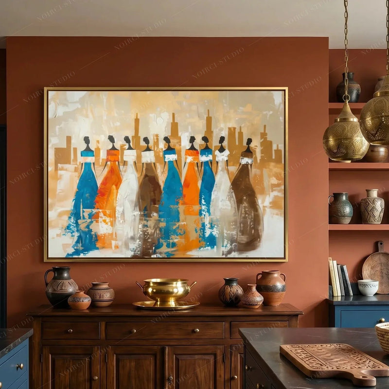 Ancestors Black women wall art in a gold frame on a terracotta kitchen wall above a dark wood sideboard