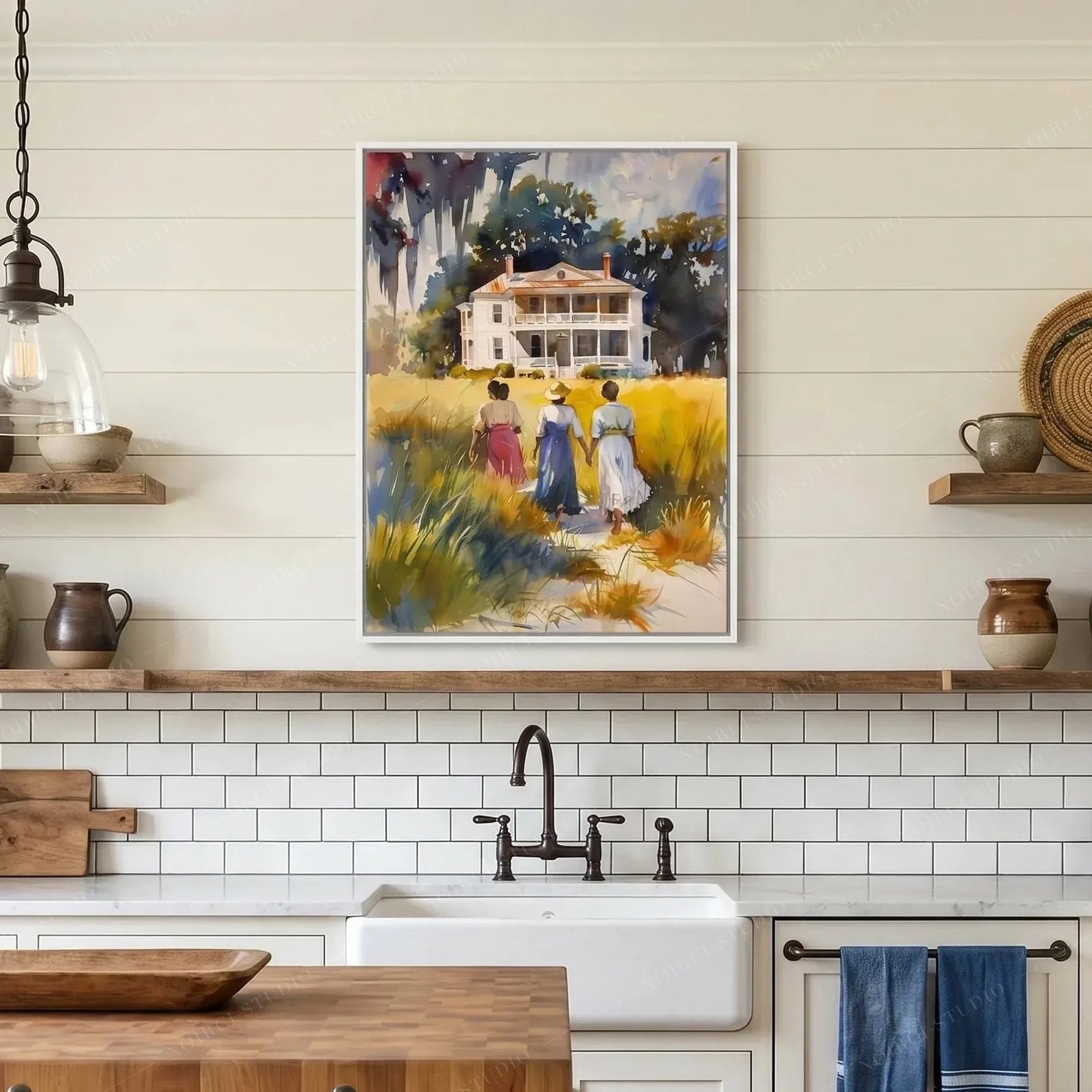 Lowcountry kitchen art, Gullah watercolor in a white frame on a wood shelf above farmhouse subway tile