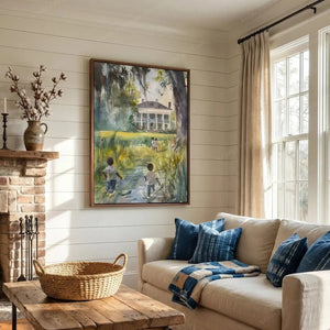 Framed lowcountry watercolor above a cream sofa with indigo pillows, shiplap living room with a brick fireplace