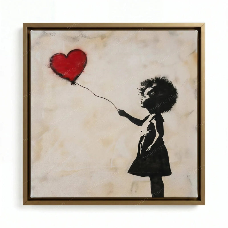 Black girl wall art in a gold floating frame, spray-paint stencil of a girl with a floating heart-shaped balloon