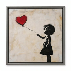 Street art canvas in a silver floating frame, silhouetted girl in a dress releasing a red heart balloon