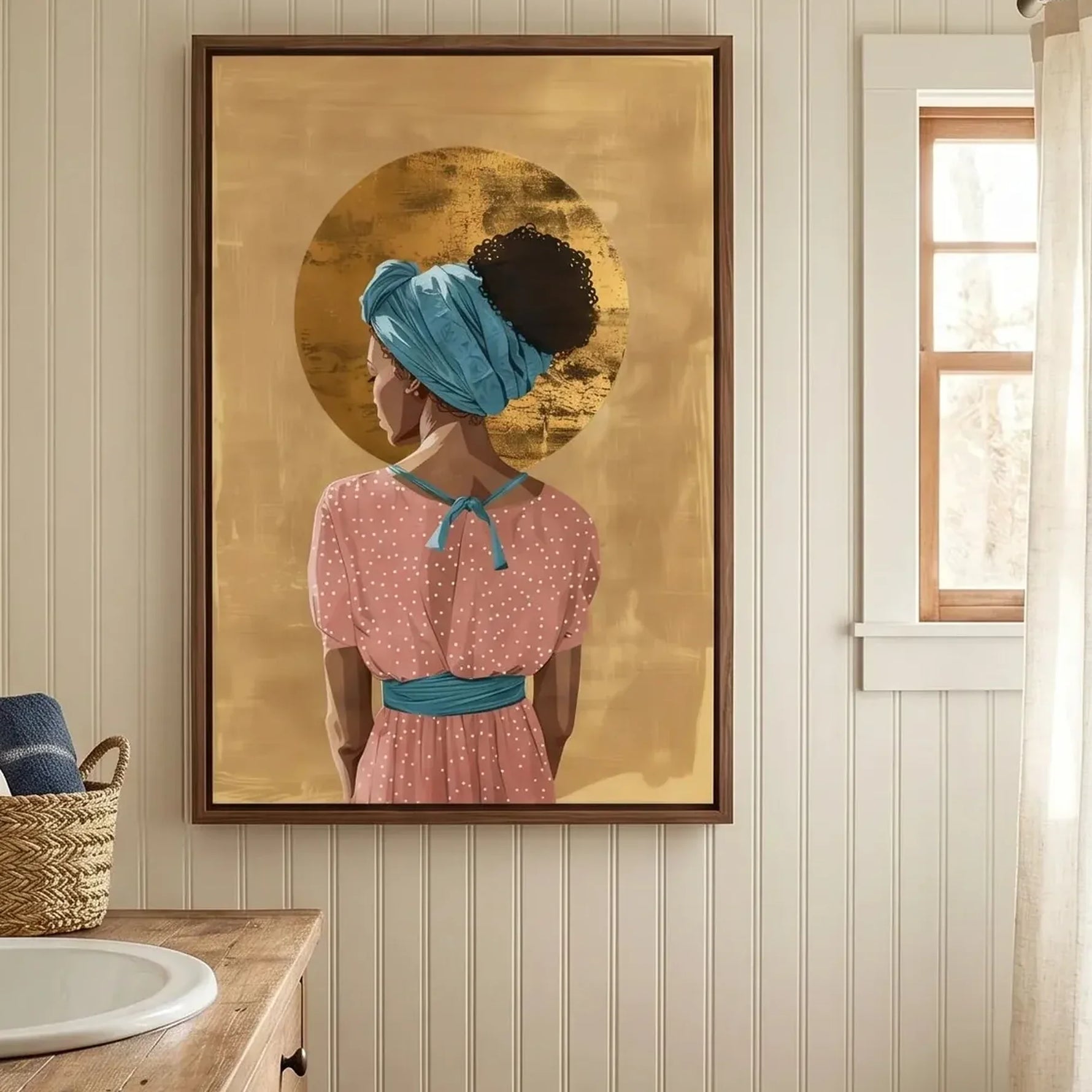 Black bathroom wall art above a wood vanity with beadboard walls, gold halo woman in a pink polka dot dress