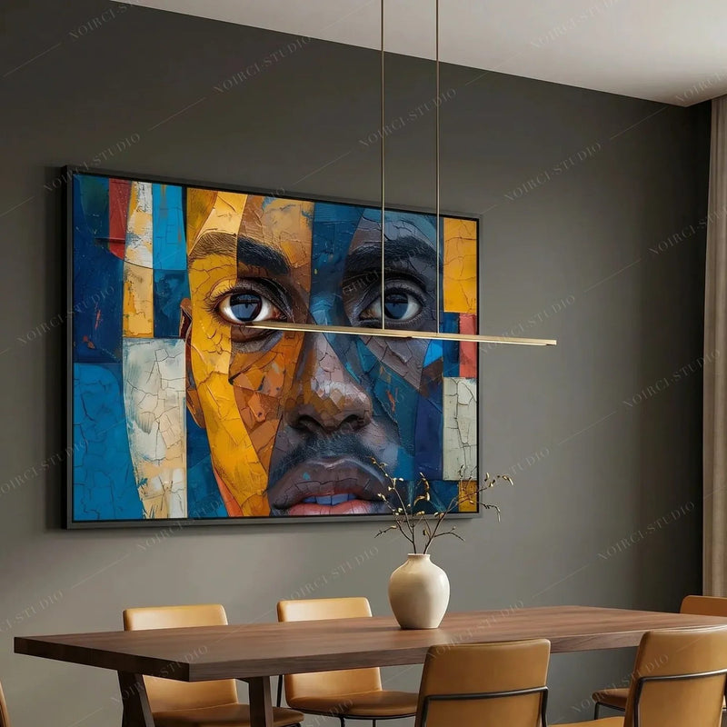 Modern Afro art in a black frame above a walnut dining table with cognac chairs in a moody charcoal dining room