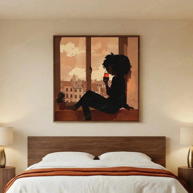 Black woman sipping wine silhouette in a bedroom with walnut headboard, white linens and a burnt orange throw