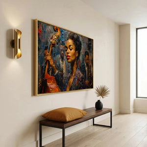 Modern Black art for an apartment entryway, gold framed jazz portrait above a bench with a camel pillow