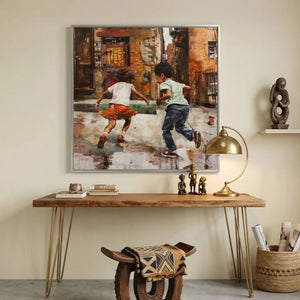 African American art for a home office, silver framed painting over a walnut console with brass lamp and carved figures