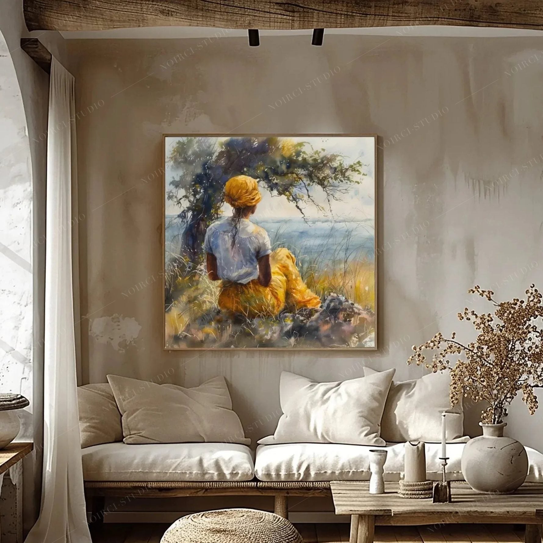 Black art for living room walls, coastal watercolor on a rustic plaster wall above a linen sofa