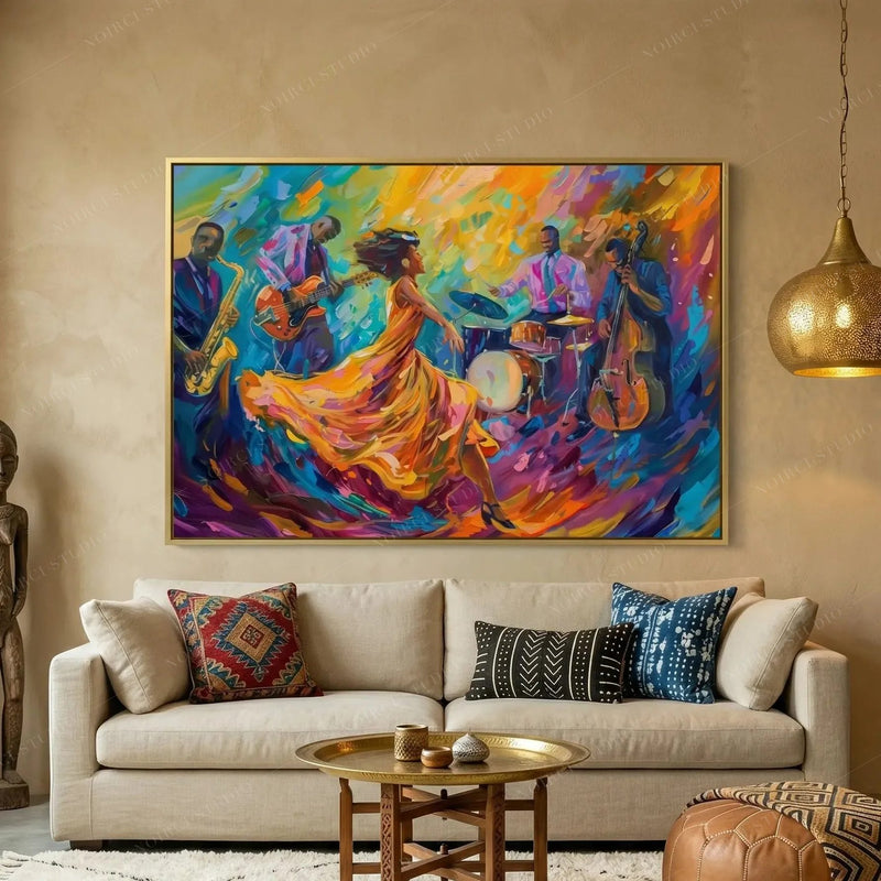 Black art for living room decor, gold-framed jazz dancer painting above a beige sofa with indigo mudcloth pillows